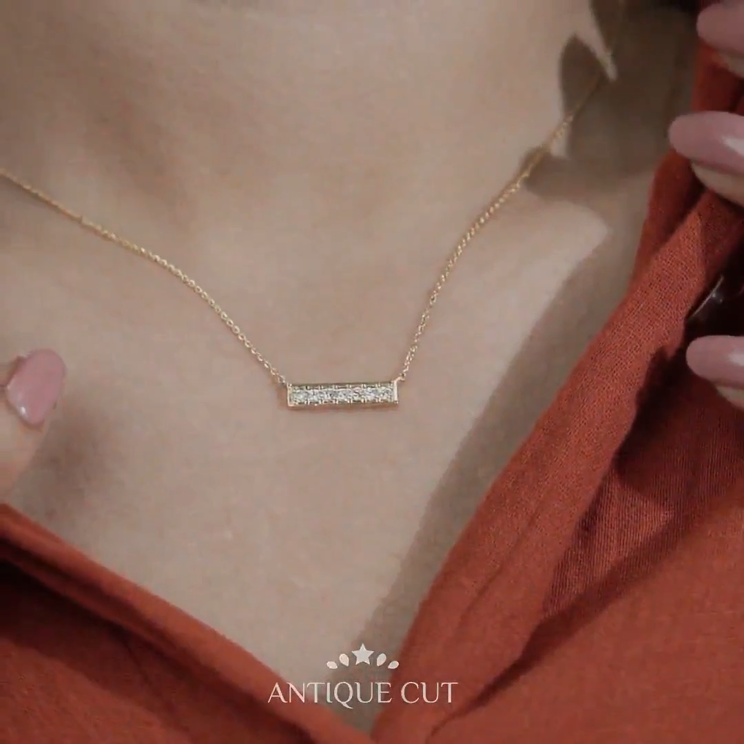 This Yellow gold diamond bar necklace shines beautifully.