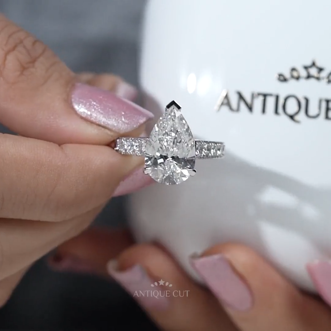 White gold pear diamond engagement ring with pave diamonds
