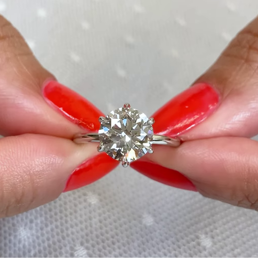 Round diamond solitaire engagement ring with four prong setting