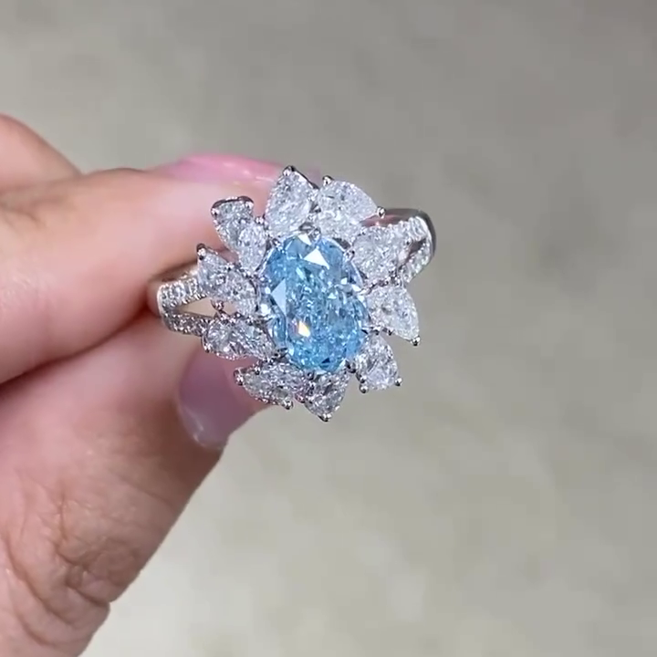 Cluster oval engagement ring with prong-set pear and marquise diamonds