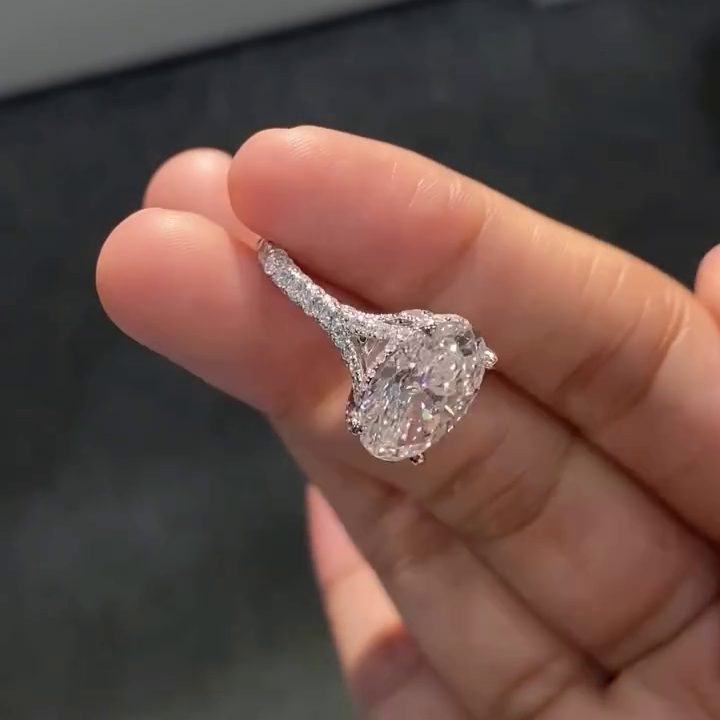 Oval cut lab grown diamond engagement ring with pavé split shank band, hidden halo